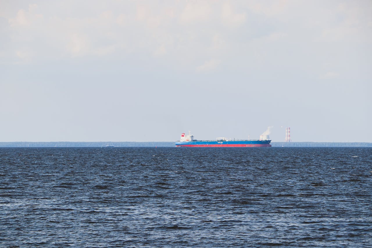gallery-1 A cargo ship sails on a calm ocean under a clear sky. Ideal for transport and maritime themes.